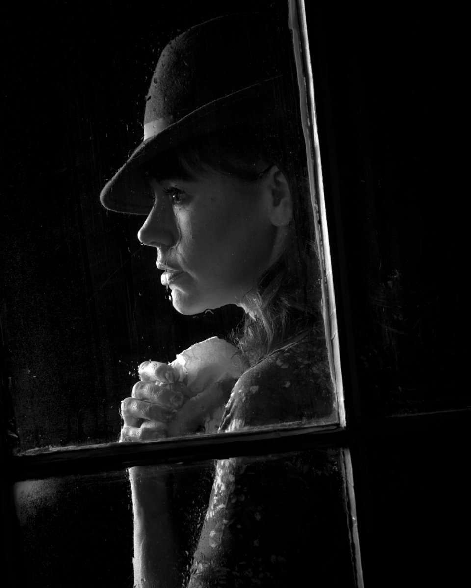 Old Hollywood style portrait by rain window
